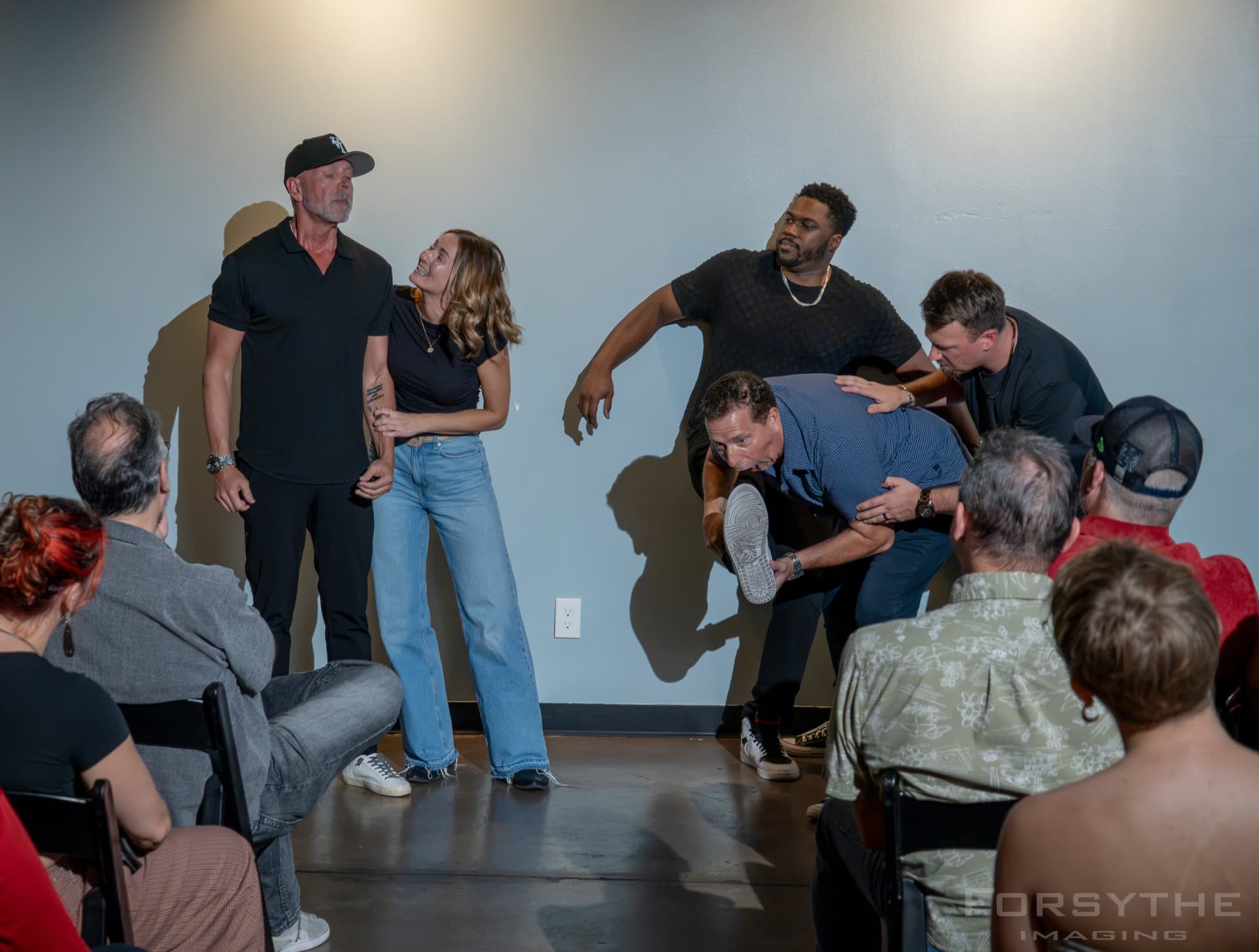 Improv scene with audience volunteers on stage at the comedy show