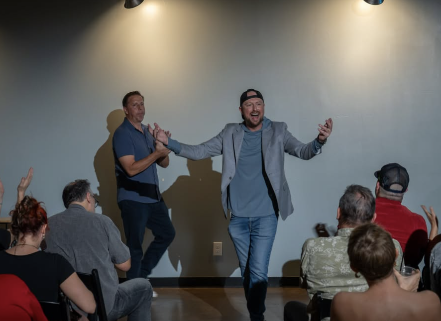 Aaron and Forbes taking a bow after a sketch